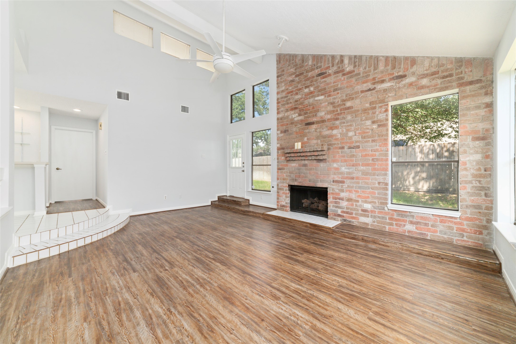 15014 Tinker Street Houston, TX 77084 - Photo 11 of 35 a view of empty room with wooden floor and fireplace