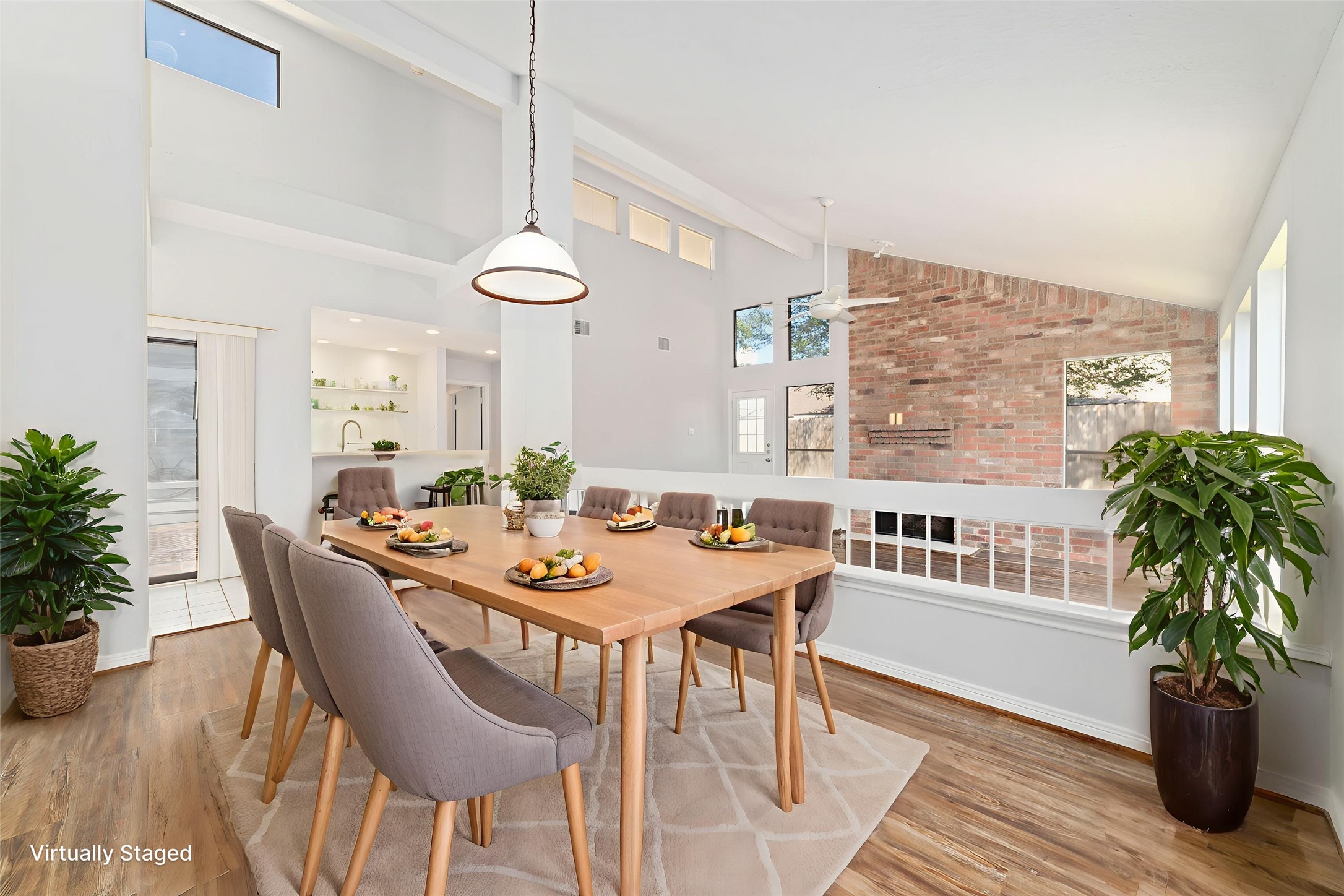 15014 Tinker Street Houston, TX 77084 - Photo 13 of 35 a dining room with furniture potted plants and wooden floor