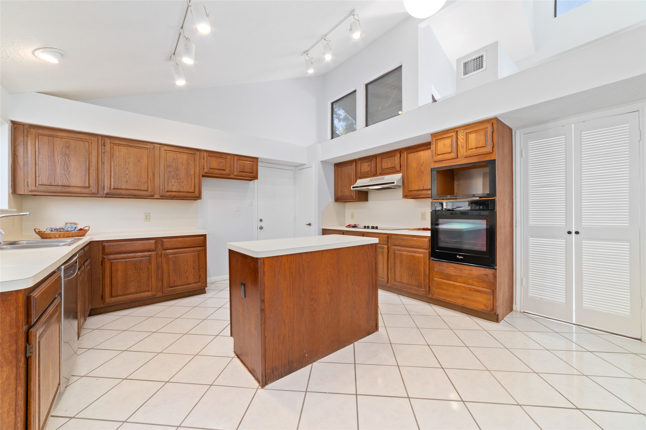 15014 Tinker Street Houston, TX 77084 - Photo 15 of 35 a kitchen with stainless steel appliances a stove a sink and a refrigerator