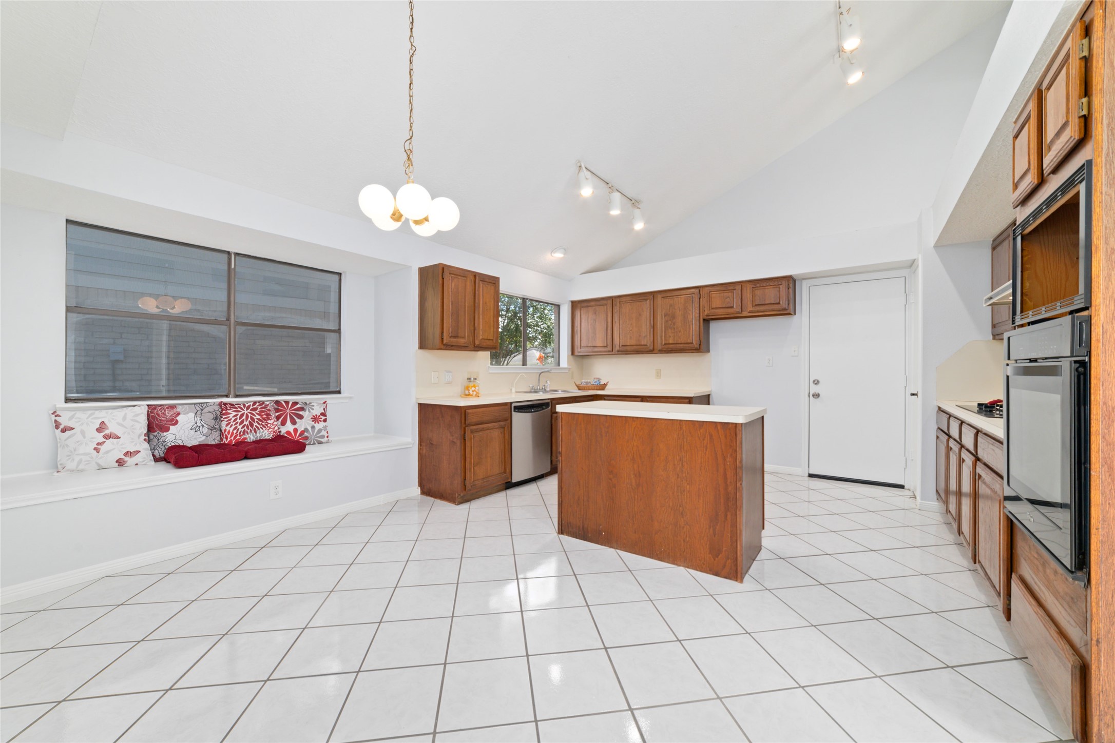15014 Tinker Street Houston, TX 77084 - Photo 18 of 35 a large kitchen with stainless steel appliances kitchen island granite countertop a sink and cabinets