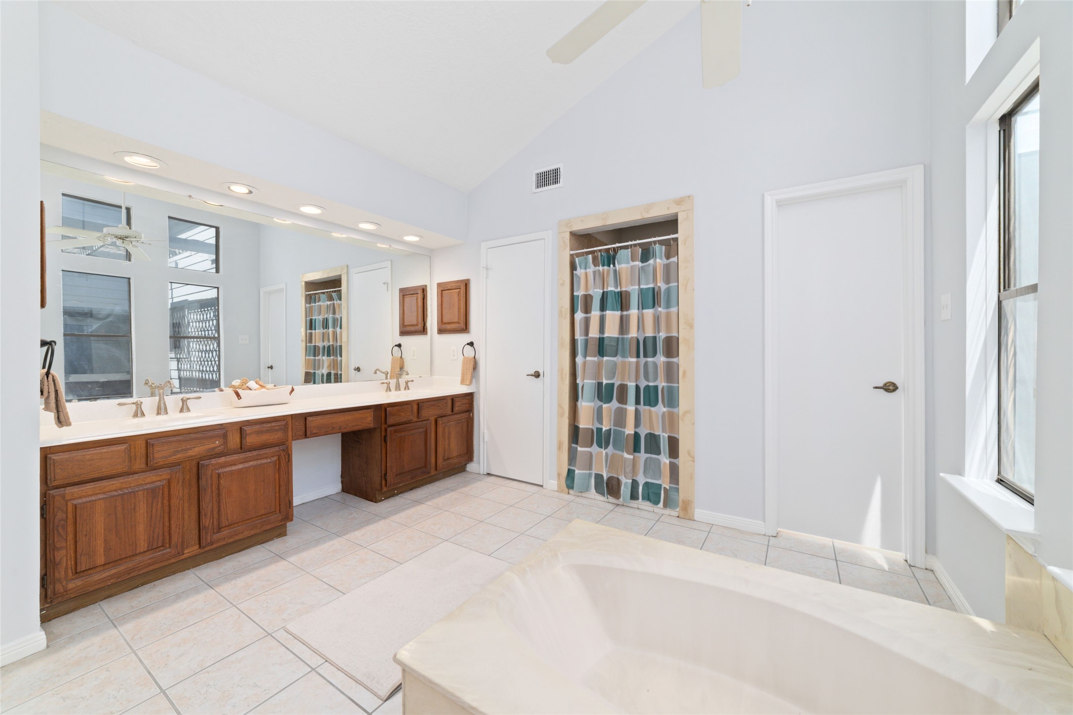 15014 Tinker Street Houston, TX 77084 - Photo 26 of 35 a large white bathroom with a granite countertop sink mirror and a bathtub