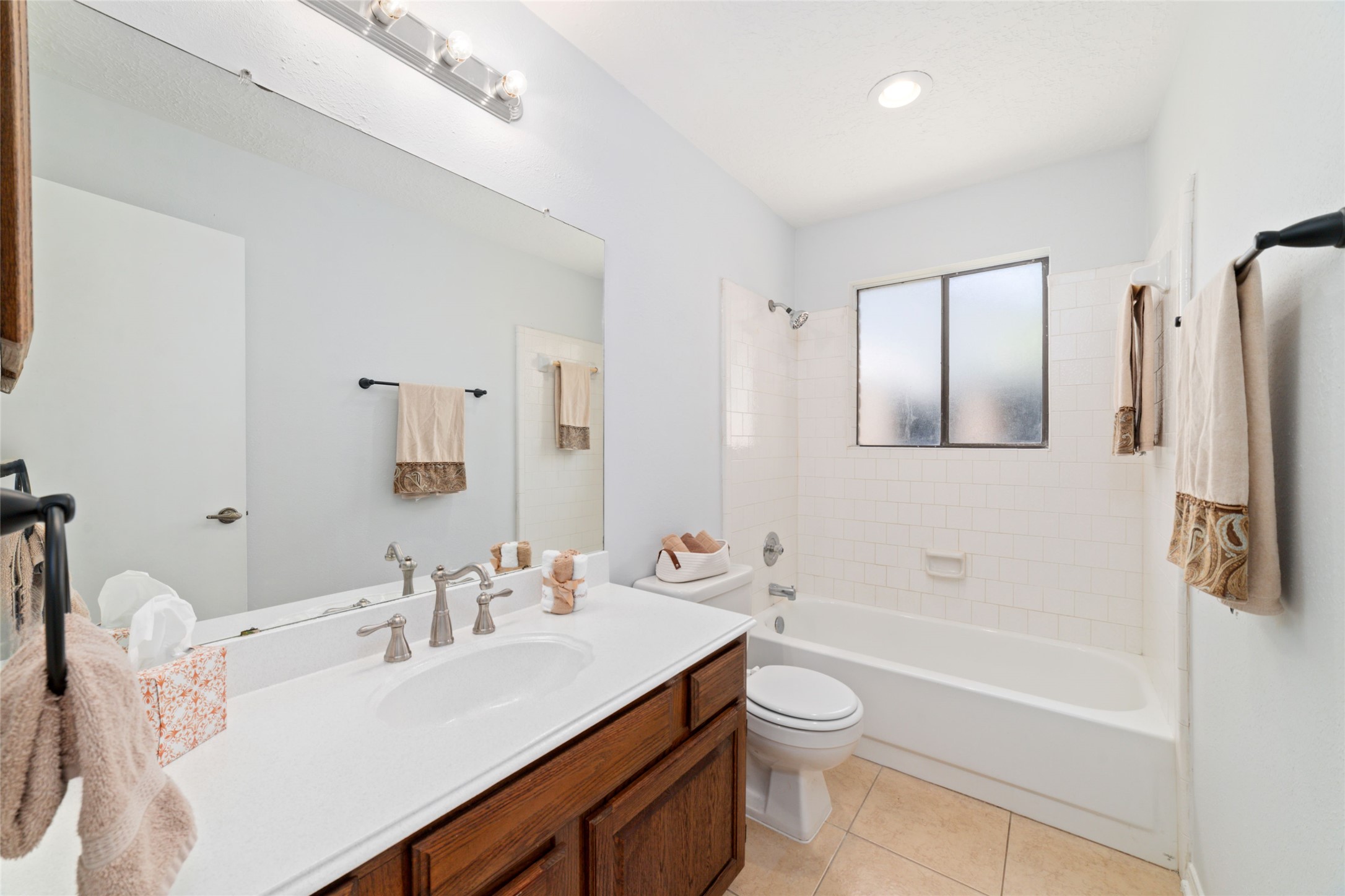 15014 Tinker Street Houston, TX 77084 - Photo 30 of 35 a bathroom with a granite countertop sink toilet a mirror and shower