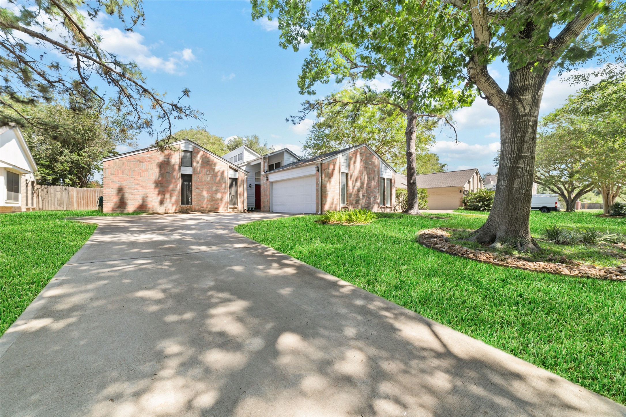 15014 Tinker Street Houston, TX 77084 - Photo 3 of 35 a front view of a house with a yard and large trees