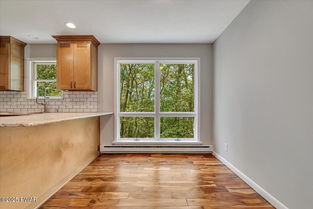 107 Kiel Road Milford, PA 18337 - Photo 16 of 71 a view of an empty room with wooden floor and a window