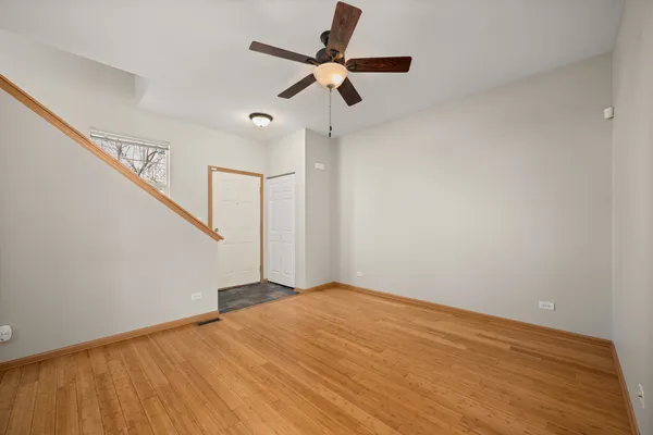 a view of an empty room with a ceiling fan