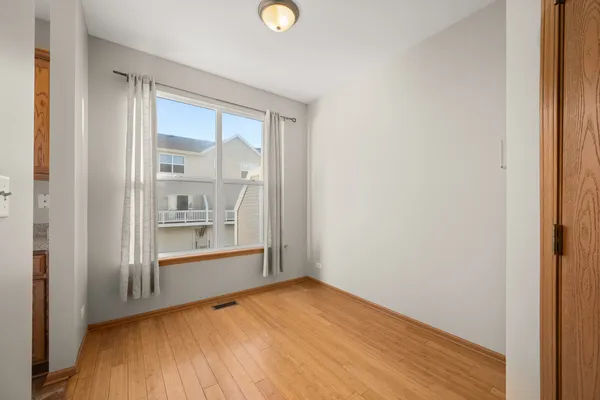 a view of empty room with wooden floor