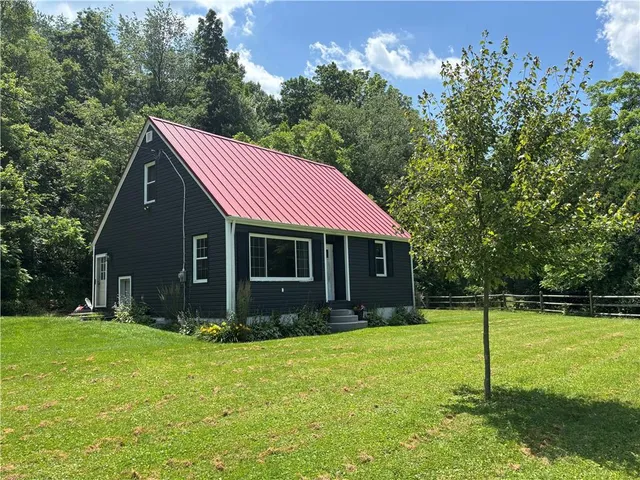 a view of house with yard and green space