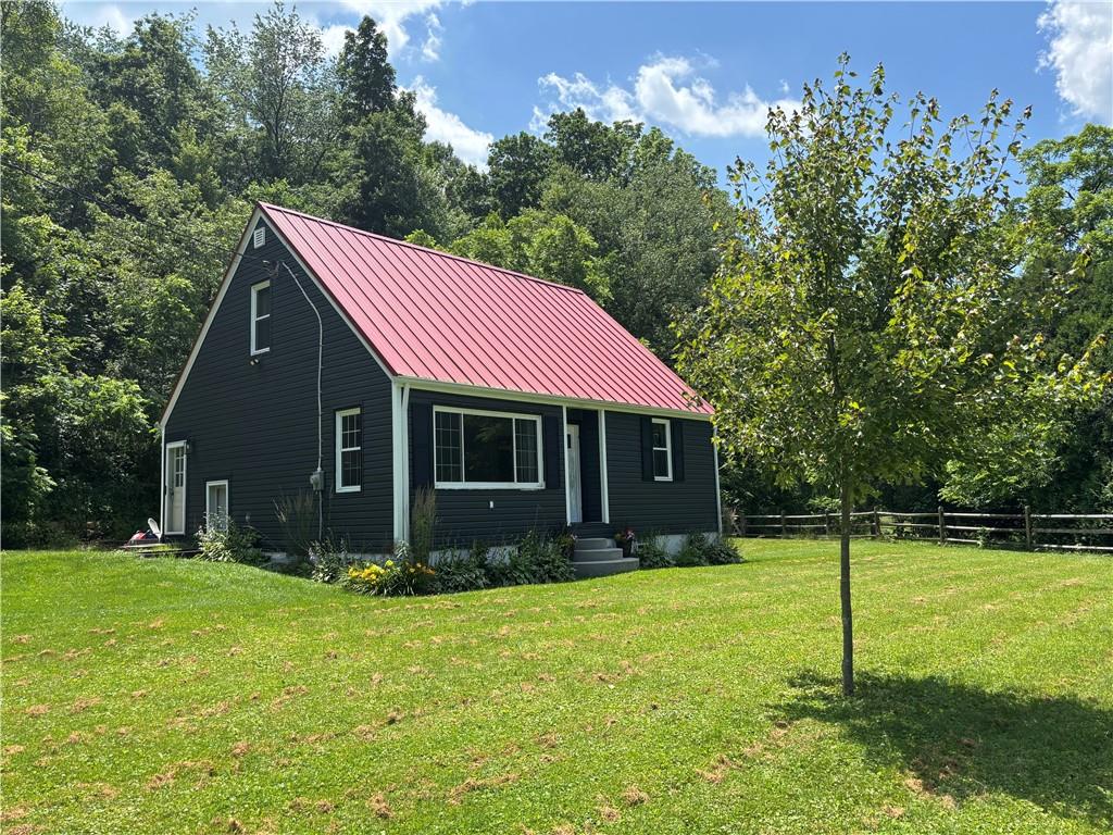 a view of house with yard and green space