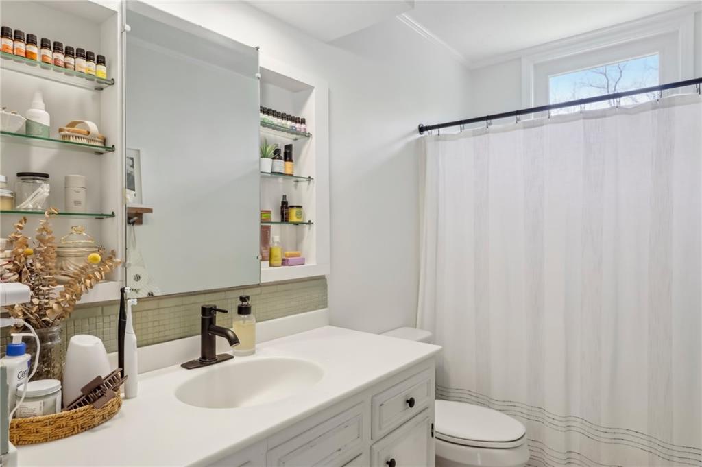 2263 Lovi Road Freedom, PA 15042 - Photo 14 of 22 a bathroom with a sink toilet a mirror and shower curtain