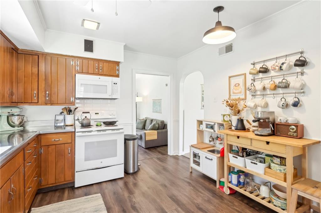 2263 Lovi Road Freedom, PA 15042 - Photo 7 of 22 a kitchen filled with stainless steel appliances granite countertop a sink dishwasher stove and white cabinets with wooden floor