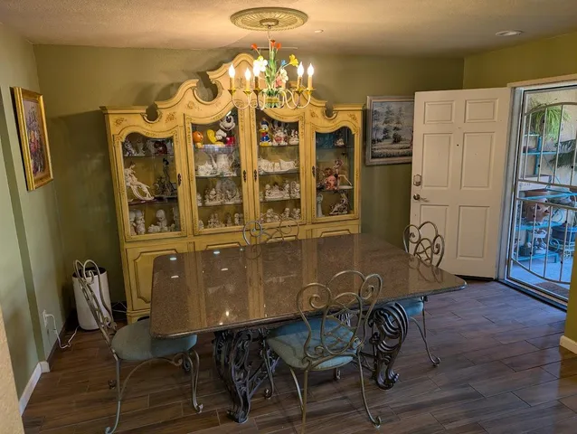 a view of a dining room with furniture and chandelier
