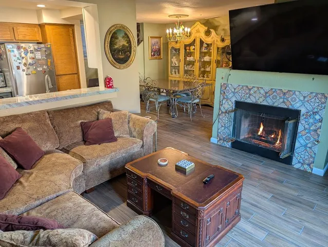 a living room with furniture a flat screen tv and a fireplace