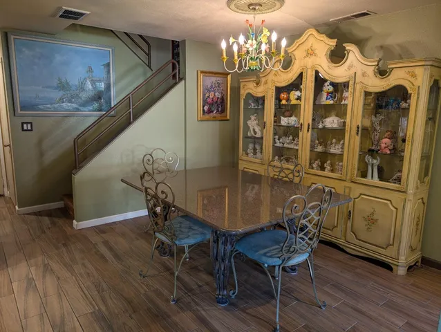 a view of a room with furniture and chandelier