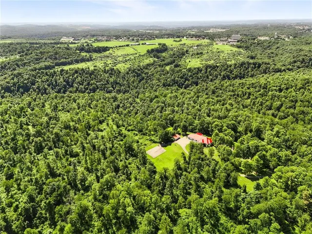 an aerial view of a houses with a yard
