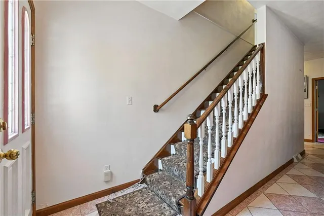 a view of staircase with wooden floor and white walls