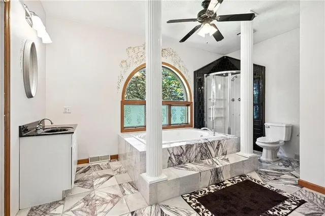 a living room with furniture a rug and white walls