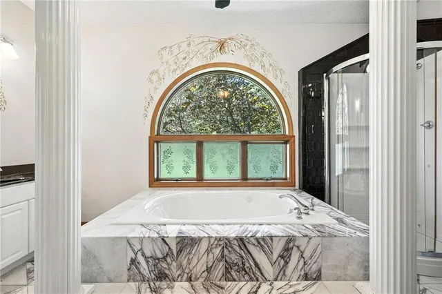 a view of a bedroom with a bed and a window