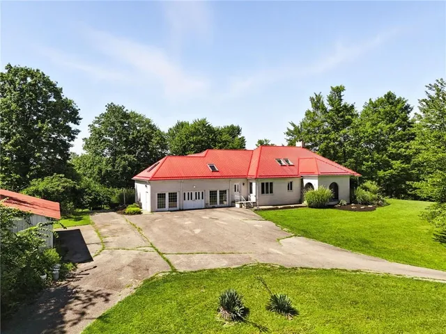 a view of a house with a yard and sitting area