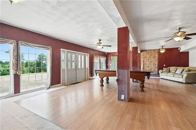 a view of living room filled with furniture and floor to ceiling window