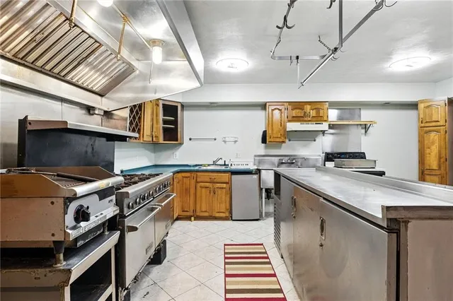 a kitchen with a sink appliances and cabinets