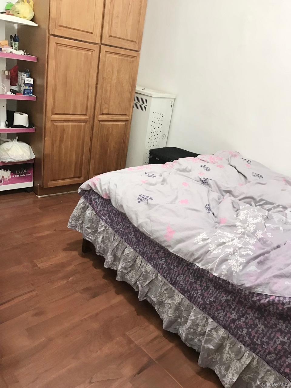 98-08 Alstyne Avenue Queens, NY 11368 - Photo 5 of 7 a bedroom with bed and closet