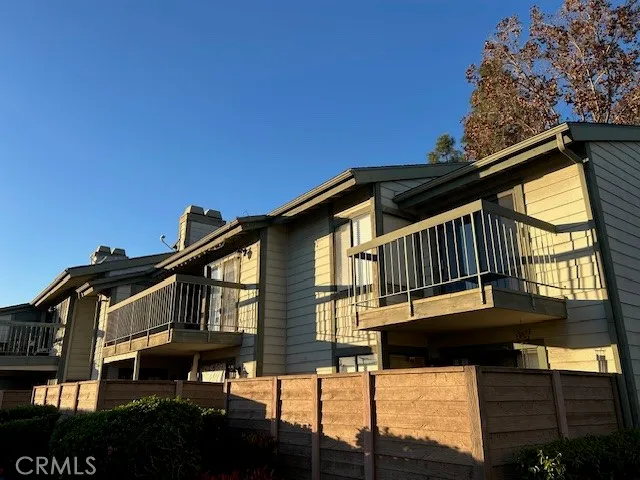 a front view of a house with a wooden fence