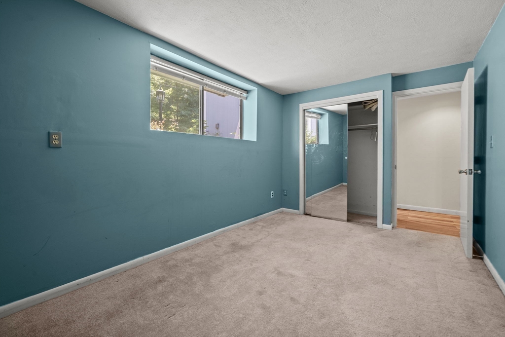 374 Great Road, Unit 11 Acton, MA 01720 - Photo 13 of 30 an empty room with windows and closet