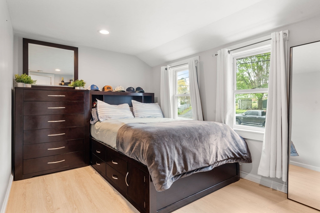 7 Indian Neck Road Wareham, MA 02571 - Photo 28 of 34 a bedroom with a bed and a mirror