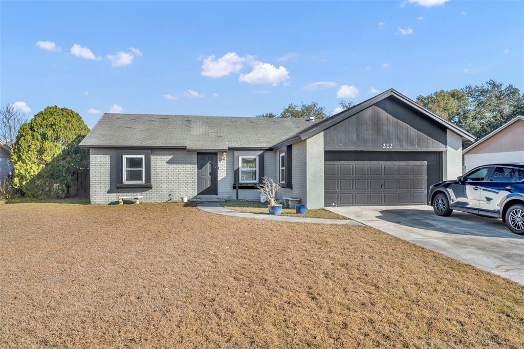 222 West Panama Road Winter Springs, FL 32708 - Photo 2 of 25 a front view of a house with a yard and garage