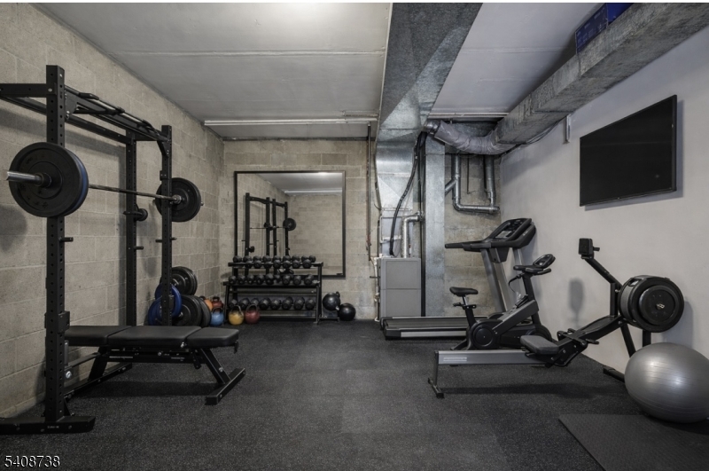 27 Espy Road, Unit A7 Caldwell, NJ 07006 - Photo 26 of 29 a room with gym equipment and windows