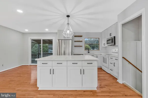 a kitchen with stainless steel appliances granite countertop a stove oven and a refrigerator