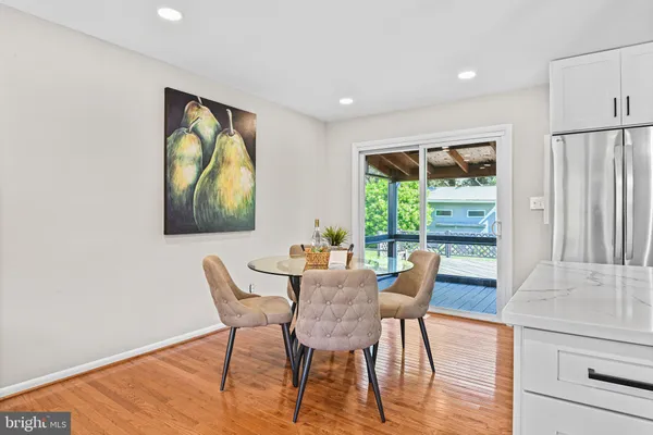 a dining room with furniture and a window
