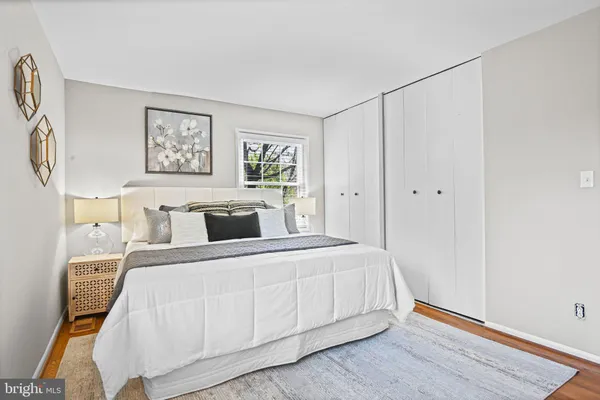 a bedroom with a bed and a night stand