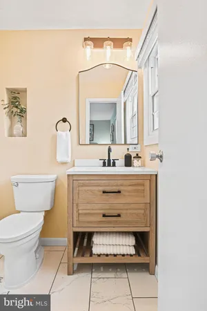 a bathroom with a sink toilet and mirror