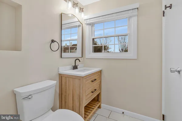 a bathroom with a toilet sink and mirror