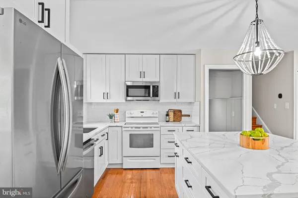 a kitchen with stainless steel appliances a stove a refrigerator and a sink