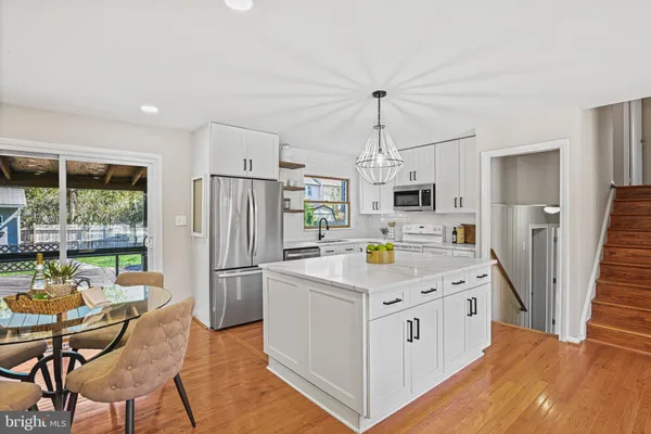 a kitchen with stainless steel appliances a refrigerator and a stove top oven