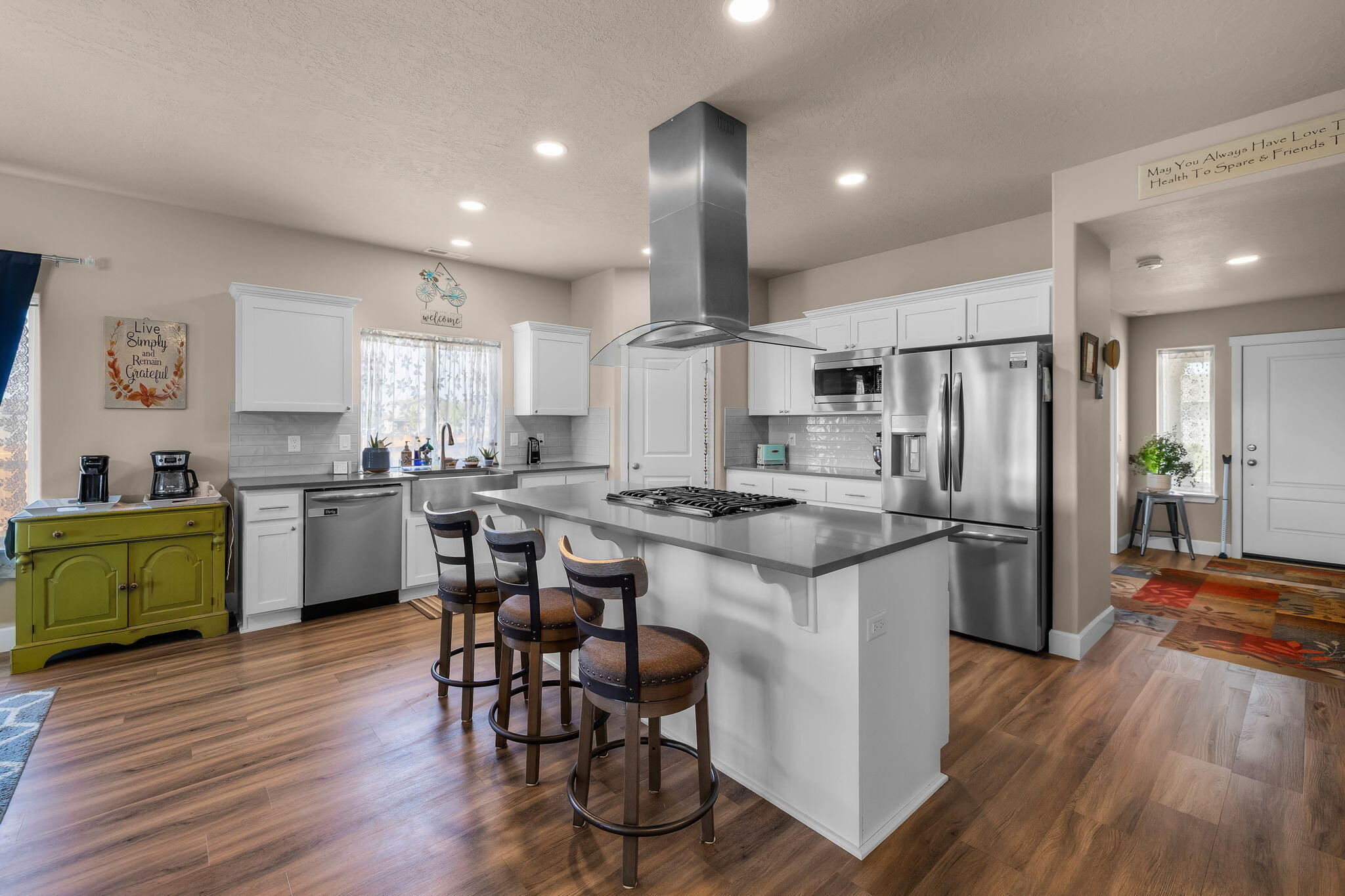 1132 Northwest Golf Course Drive Madras, OR 97741 - Photo 6 of 36 a kitchen with white cabinets and stainless steel appliances