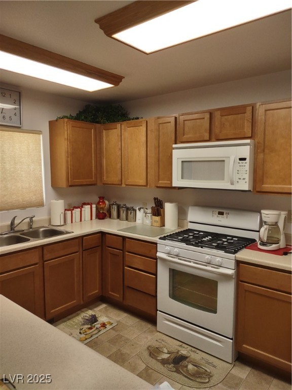 301 South Gold Street Manhattan, NV 89022 - Photo 11 of 16 Kitchen with stove, light countertops, and brown cabinets