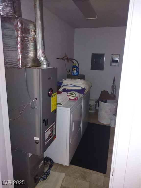 301 South Gold Street Manhattan, NV 89022 - Photo 16 of 16 Laundry area with washer and dryer, electric panel, and heating unit