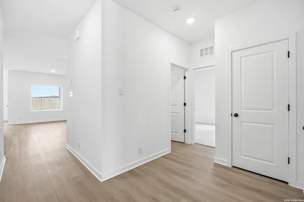 a view of a hallway with wooden floor