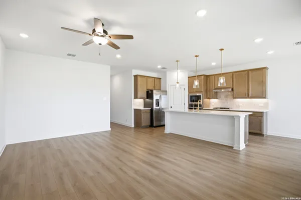 a view of kitchen with kitchen island white cabinets and stainless steel appliances