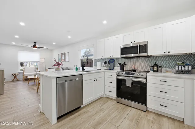a kitchen with sink cabinets and stainless steel appliances