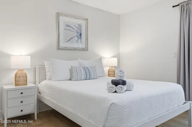 a bedroom with a bed and lamp