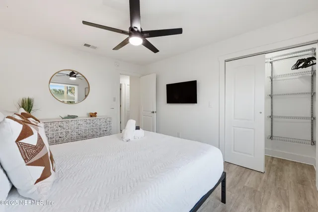 a bedroom with a bed and a flat screen tv