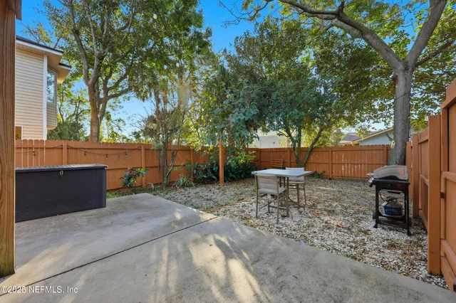 a backyard of a house with table and chairs