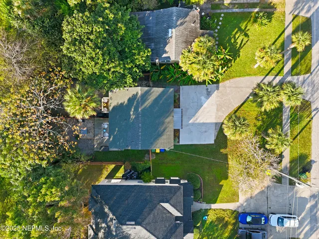 an aerial view of a house with a yard