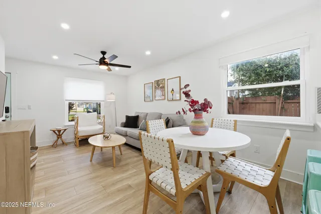 a dining room with furniture a window and wooden floor