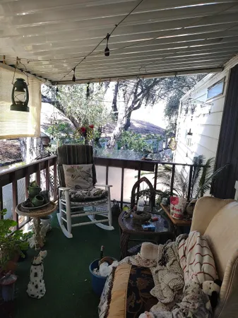 a view of a backyard with plants and wooden fence