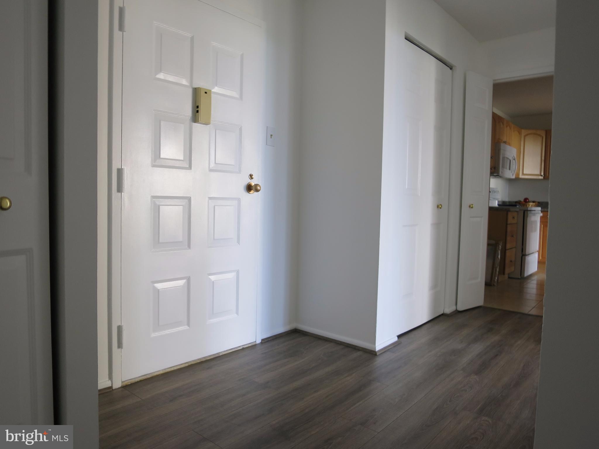 6800 Fleetwood Road, Unit 716 McLean, VA 22101 - Photo 2 of 17 an empty room with wooden floor and closet
